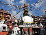 Kathmandu 04 02 Kathesimbhu Stupa On the walk from Thamel to Kathmandu Durbar Square I stopped at the Kathesimbhu Stupa, a small copy dating from around 1650 of the great Swayambhunath complex. Just as at Swayambhunath, there is a two-storey pagoda to Harti, the goddess of smallpox, right behind the main stupa. The entrance is flanked by metal lions atop red ochre concrete pillars. Various statues and smaller chaityas (small stupas) stand around the temple, including a fine standing Avalokiteshvara statue enclosed in a glass case and protective metal cage in the northeast corner. Avalokiteshvara carries a lotus flower in his left hand, and the Dhyani Buddha Amitabha is seen in the centre of his crown.